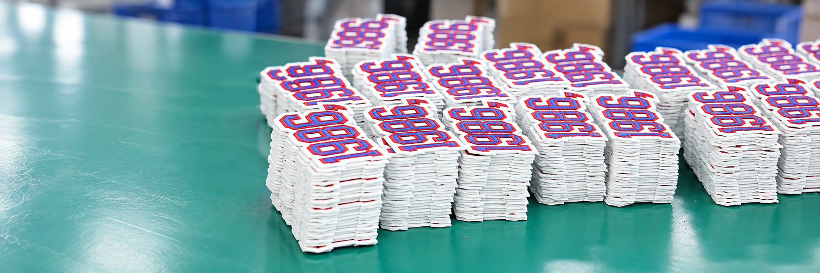 Custom patches and brand accessories packed to a buyer packing instruction at the LOVECOLOUR factory in Guangzhou.