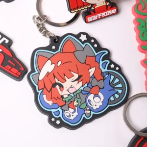 Colorful red-haired cartoon character soft PVC keychain with dark outline and metal ring.