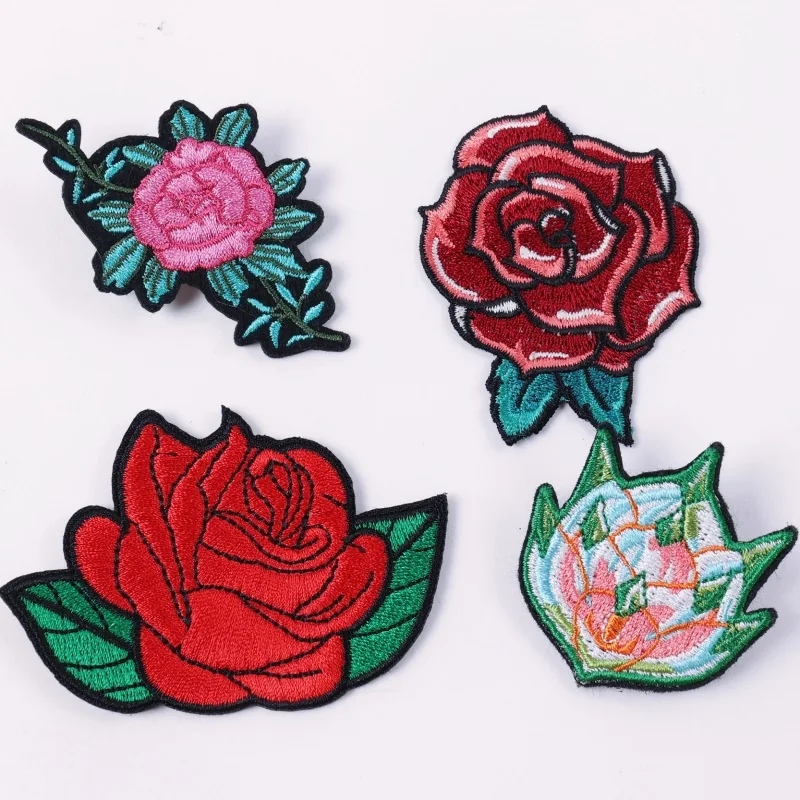 Four flower patches with pink and red roses and green leaves