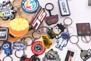 Colorful soft PVC key rings with basketball, cartoon character, logo and text designs.
