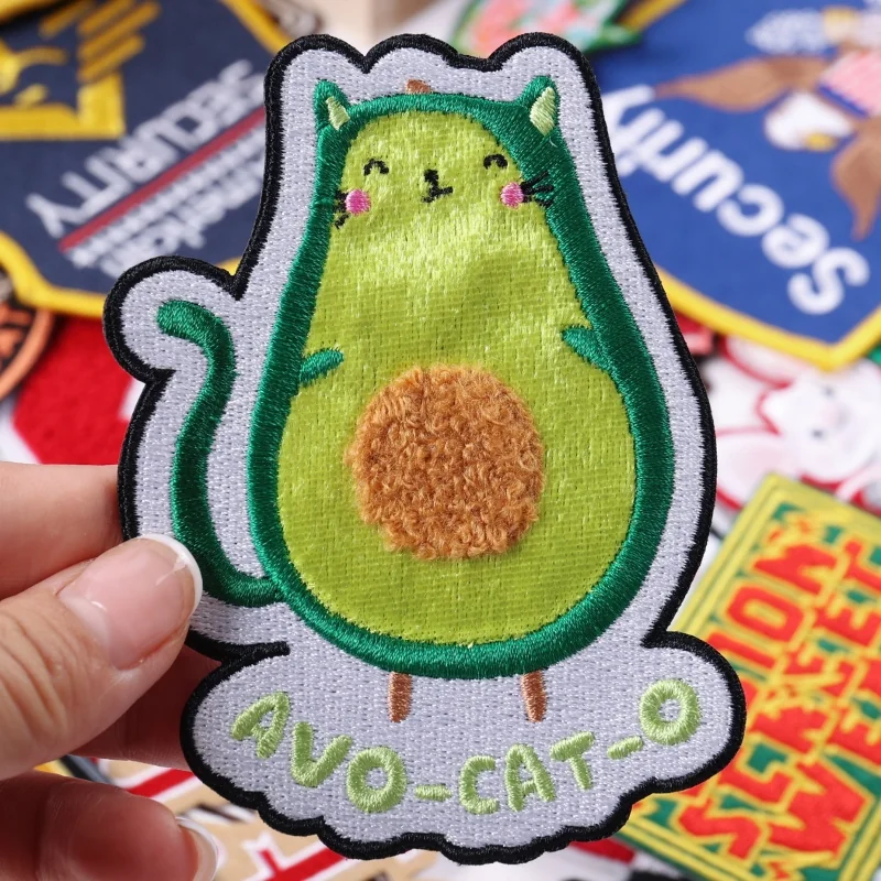 Green avocado cat embroidered patch with a raised brown chenille center