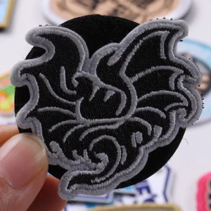 Black and gray stylized eagle logo embroidered patch with white outline