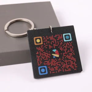 Black square PVC keychain with red dot pattern and colorful QR code