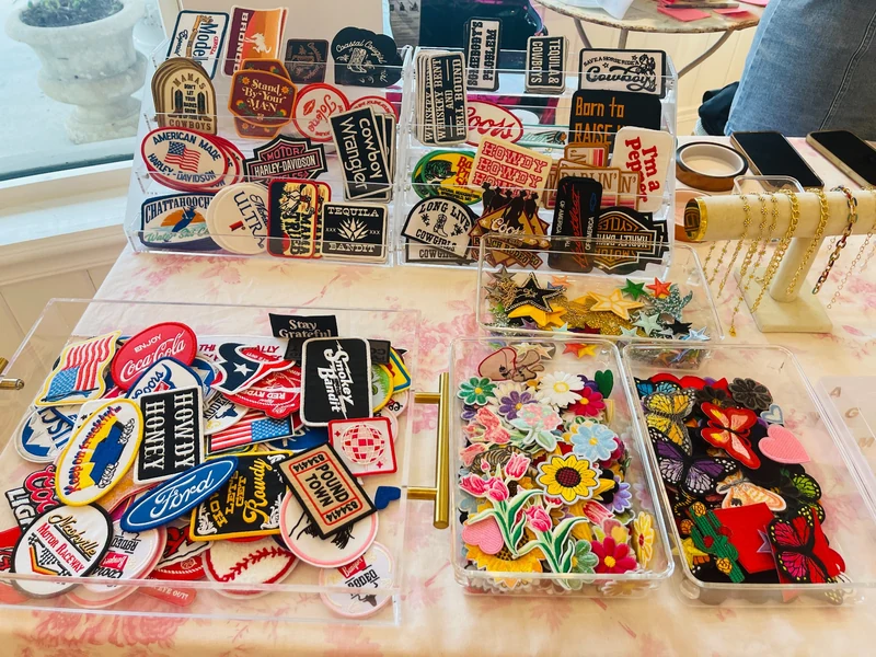 Retail table with colorful embroidered patches and hats