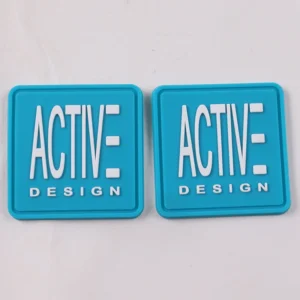 Pair of square blue PVC rubber labels with raised white Active Design logo