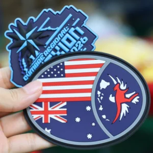 Round flag PVC patch and blue event logo patch held by hand