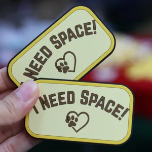 Two yellow rectangular PVC patches with Need Space text and paw heart icon