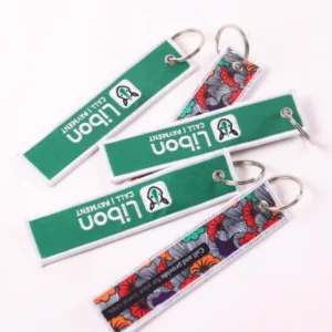 Green branded fabric keychains and patterned reverse sides with silver rings