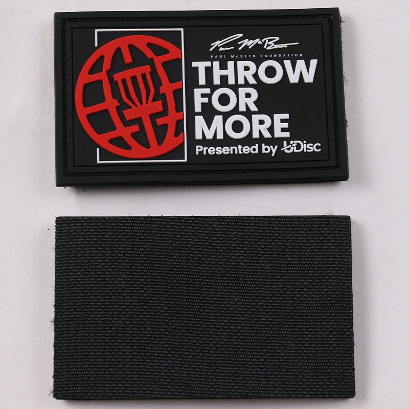Front and separate black fabric backing of a rectangular promotional PVC patch