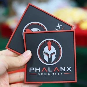 Two black and red square PVC patches with helmet security logo