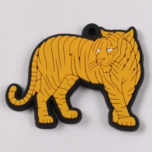 Orange tiger-shaped soft PVC tag with black outline and hanging hole