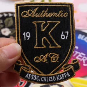 Black and gold shield-shaped vintage football club embroidered patch