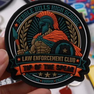 Close-up hand display of warrior law enforcement club PVC patch