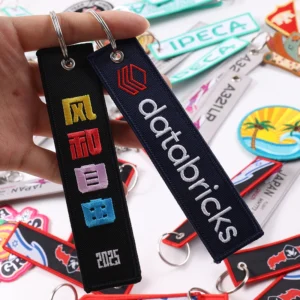 Navy Databricks key tag next to black tag with colorful symbols