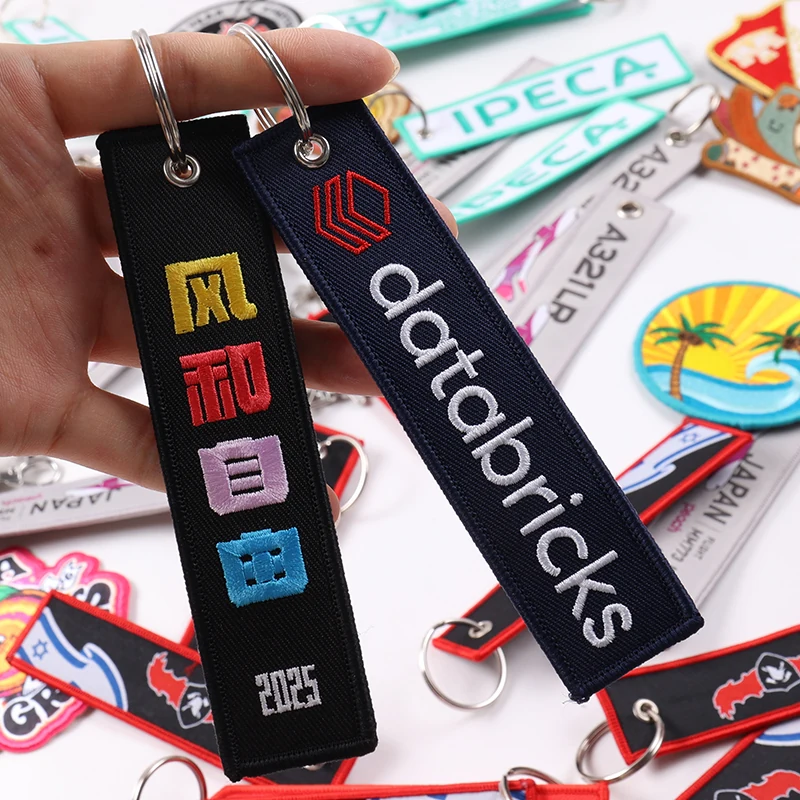Navy Databricks key tag next to black tag with colorful symbols