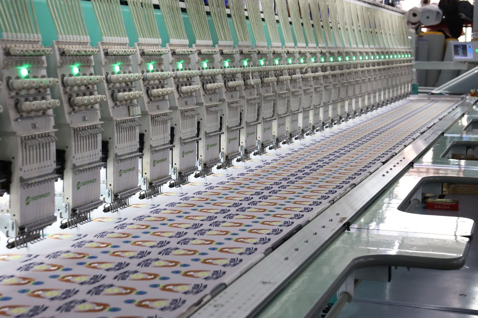 Rows of computerized multi-head embroidery machines stitching custom patches at the LOVECOLOUR factory in Guangzhou.