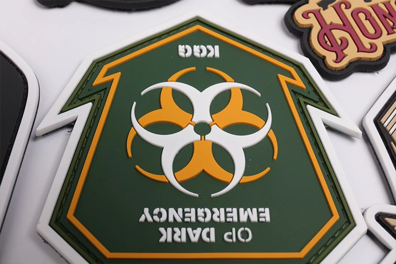 Green shield-shaped emergency biohazard PVC patch with yellow and white details