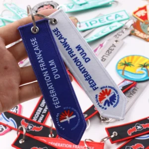 Blue and white Fédération Française d’ULM fabric key tags with rings