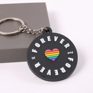 Black round Forever Pride PVC keychain with rainbow heart and metal key ring