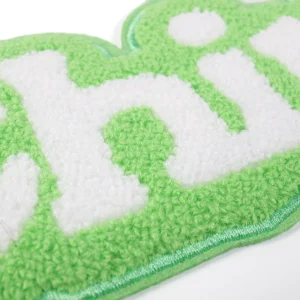 Close-up of green and white chenille letter patch with soft raised yarn