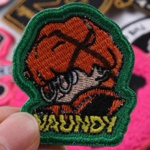 Orange tiger head mascot embroidered patch with green border and Molly text