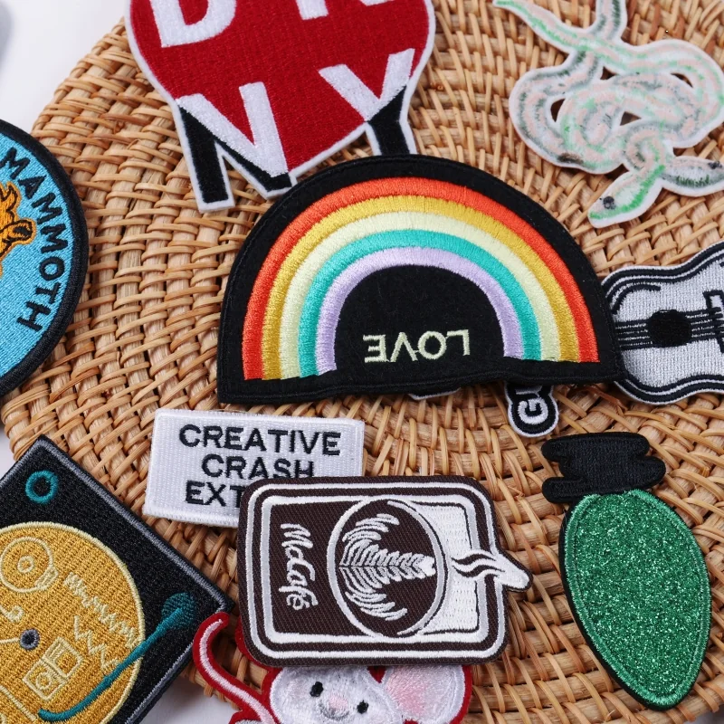 Rainbow patch with LOVE lettering beside assorted embroidered designs