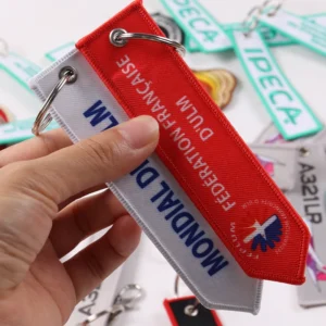 Red and white Fédération Française d’ULM fabric key tags held together