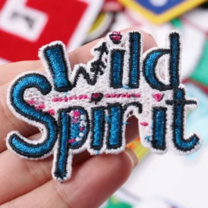 Wild Spirit lettering patch in blue black white and pink embroidery