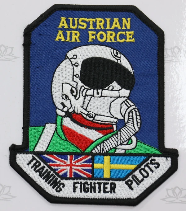 Blue AUSTRIAN AIR FORCE patch with a white pilot helmet, yellow lettering, flag details and a black finished border.