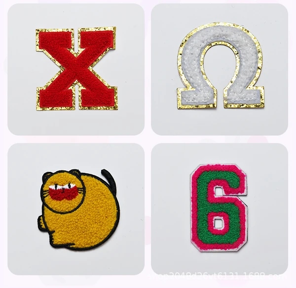 Four chenille patches: a red X and white omega with gold glitter borders, a yellow cartoon cat and a green number 6 with a pink border.