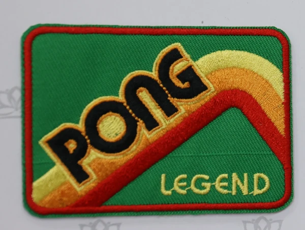 Green rectangular patch with PONG lettering, a yellow orange and red rainbow motif, LEGEND text and a red stitched outline.